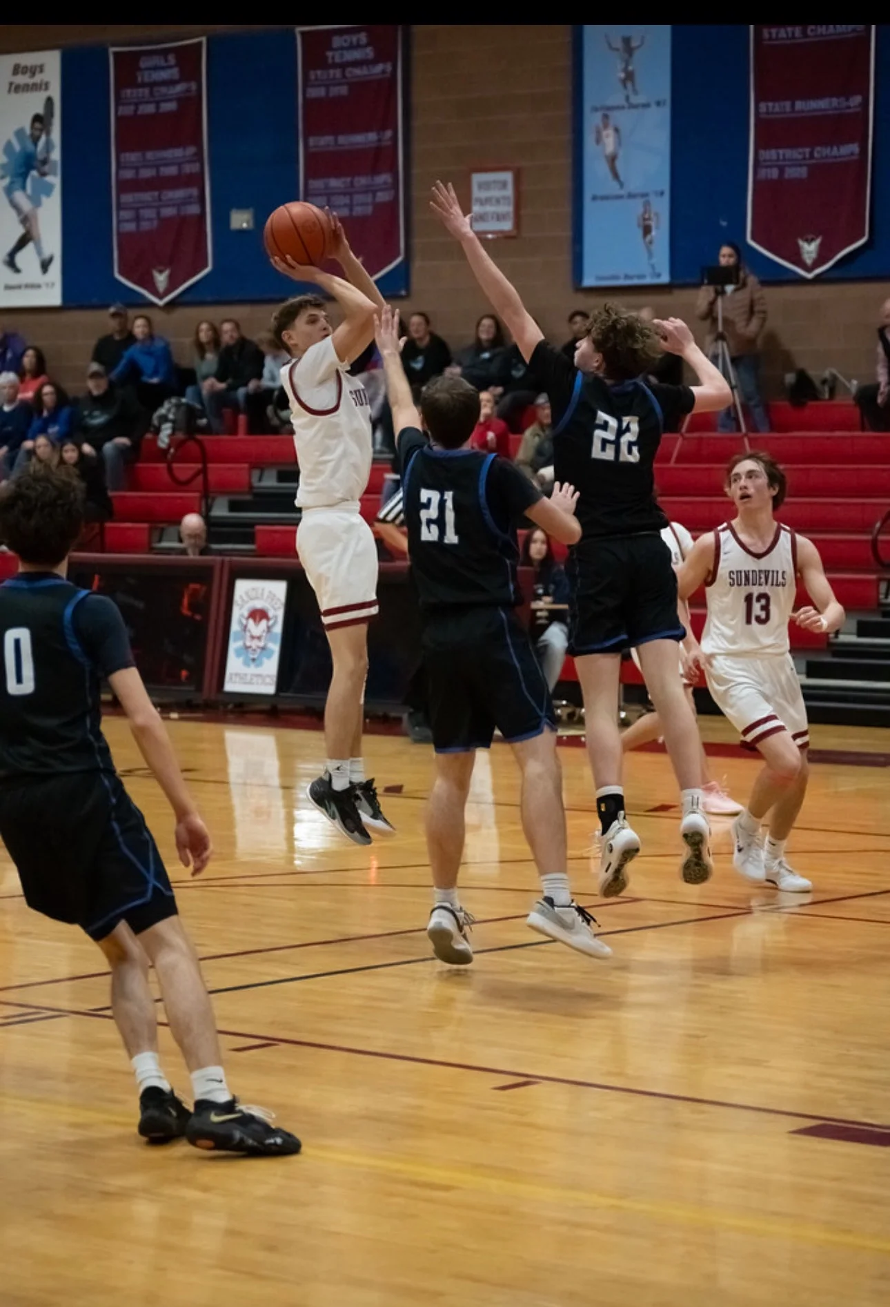 Logan Lemons playing basketball at Sandia Prep